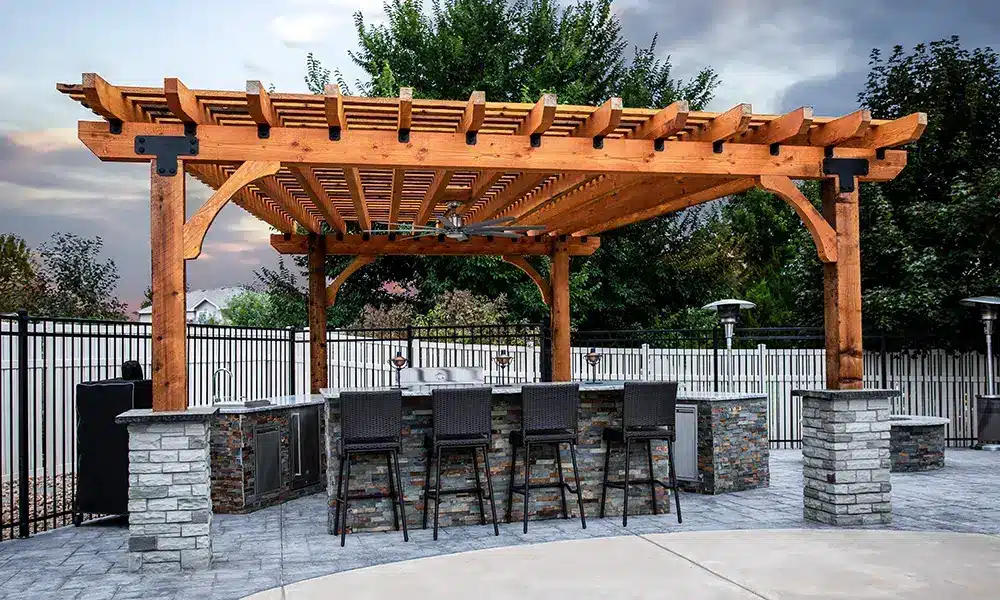 outdoor kitchen with bar top and pergola