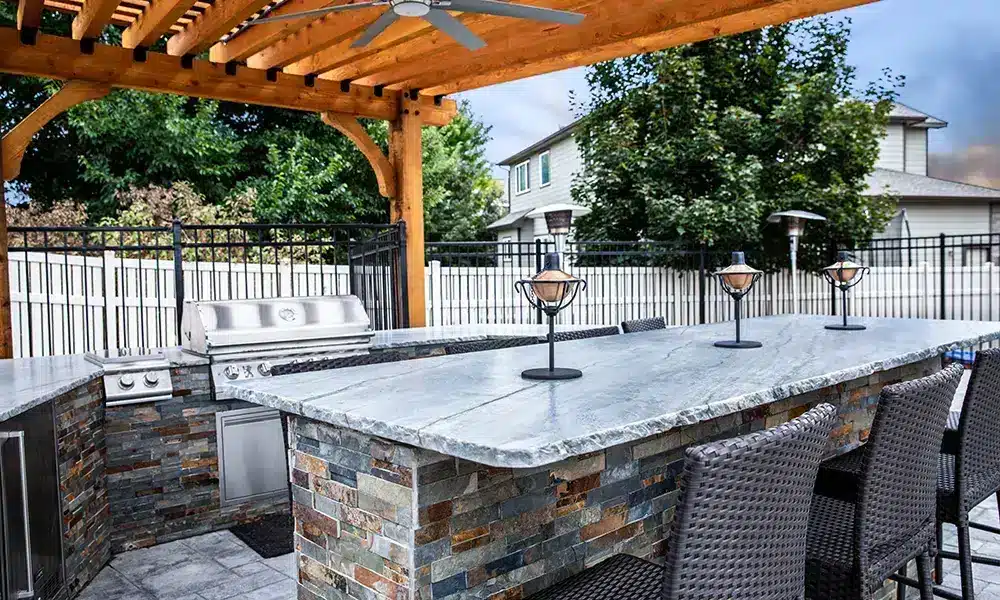 pergola with ceiling fan and dining table - outdoor kitchen contractor in Colorado