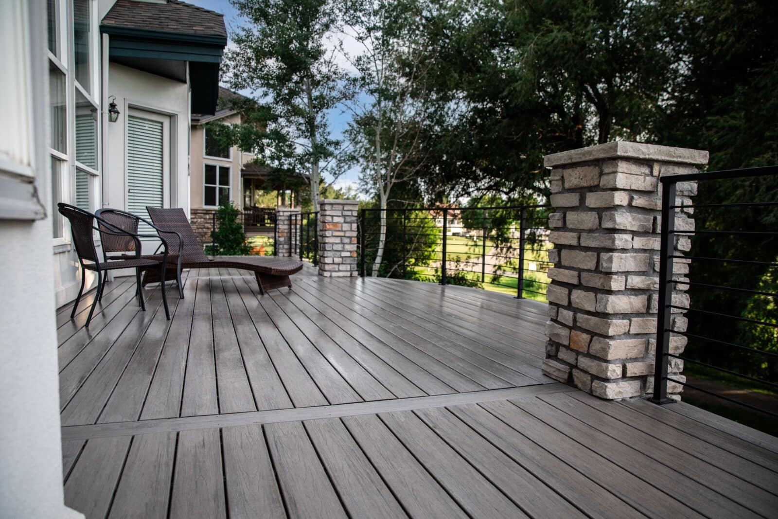 TimberTech deck with cable railing and columns.