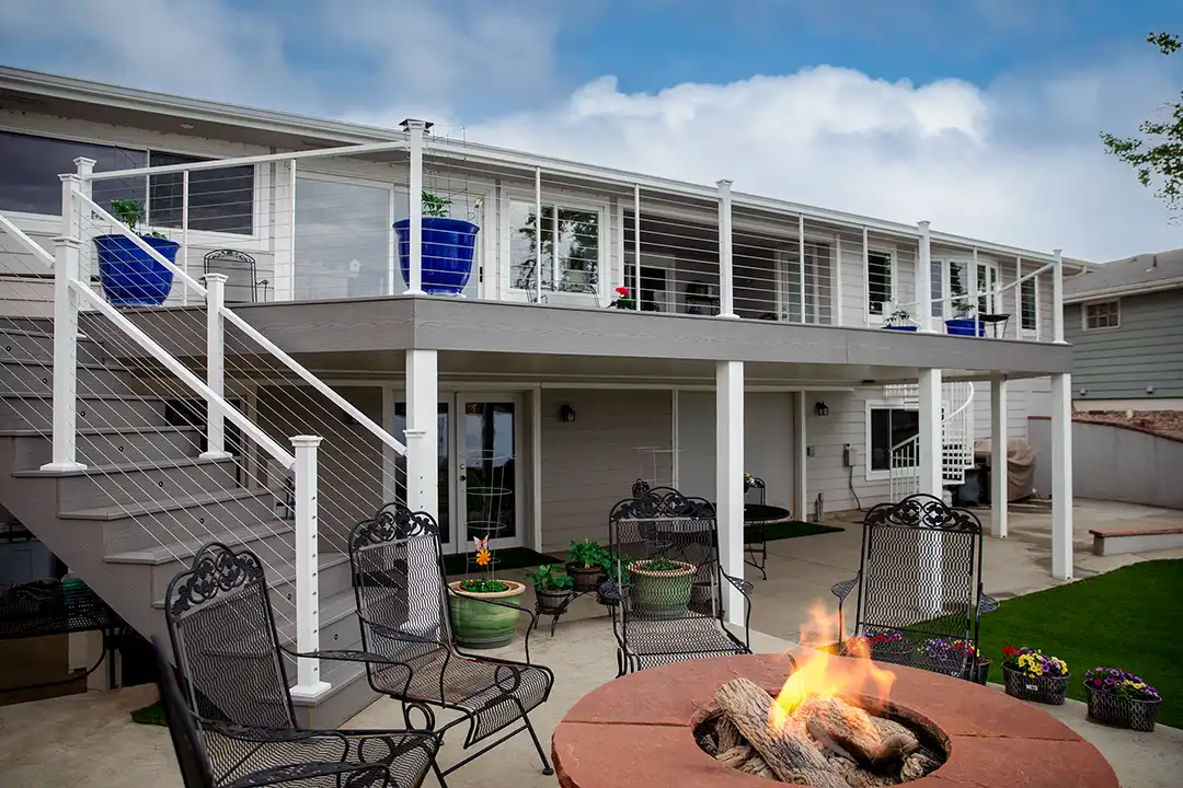 Photo of an elevated deck and patio with a fire pit.