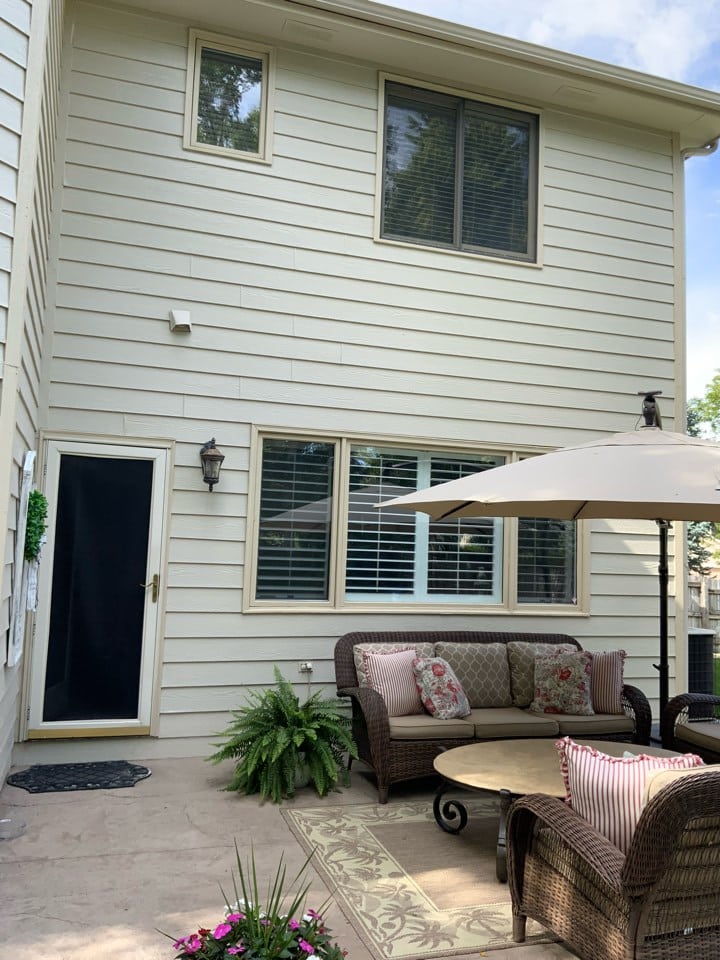 open patio with limited protection from the elements with a patio umbrella.