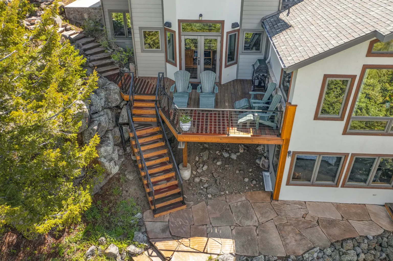 photo of a raised deck with steps and stone pavers - Custom deck builders in Castle Pines Colorado