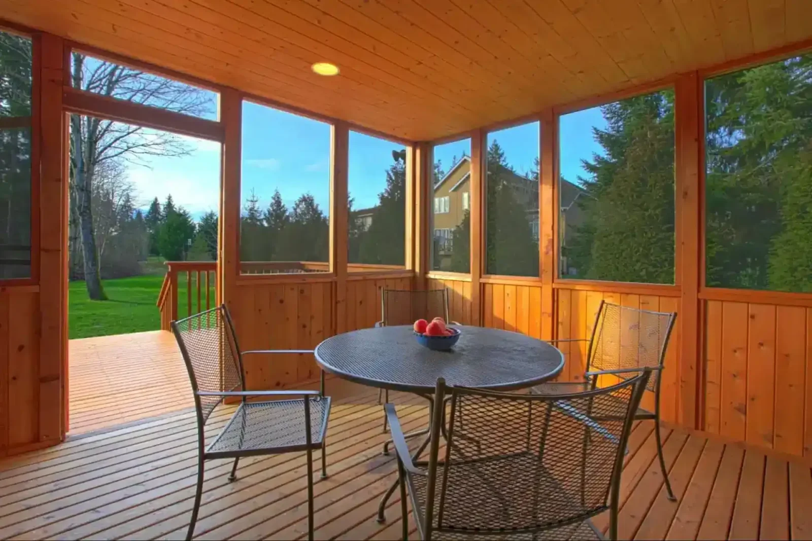 photo of screened and covered porch with table and chairs - Screened porch builders near me Colorado