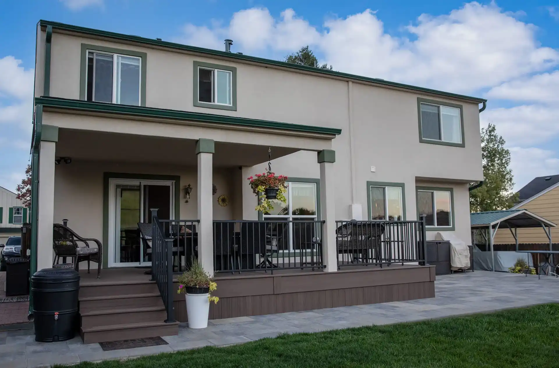 photo of a custom porch with porch columns, railing, steps, and outdoor furniture - Covered porch builders