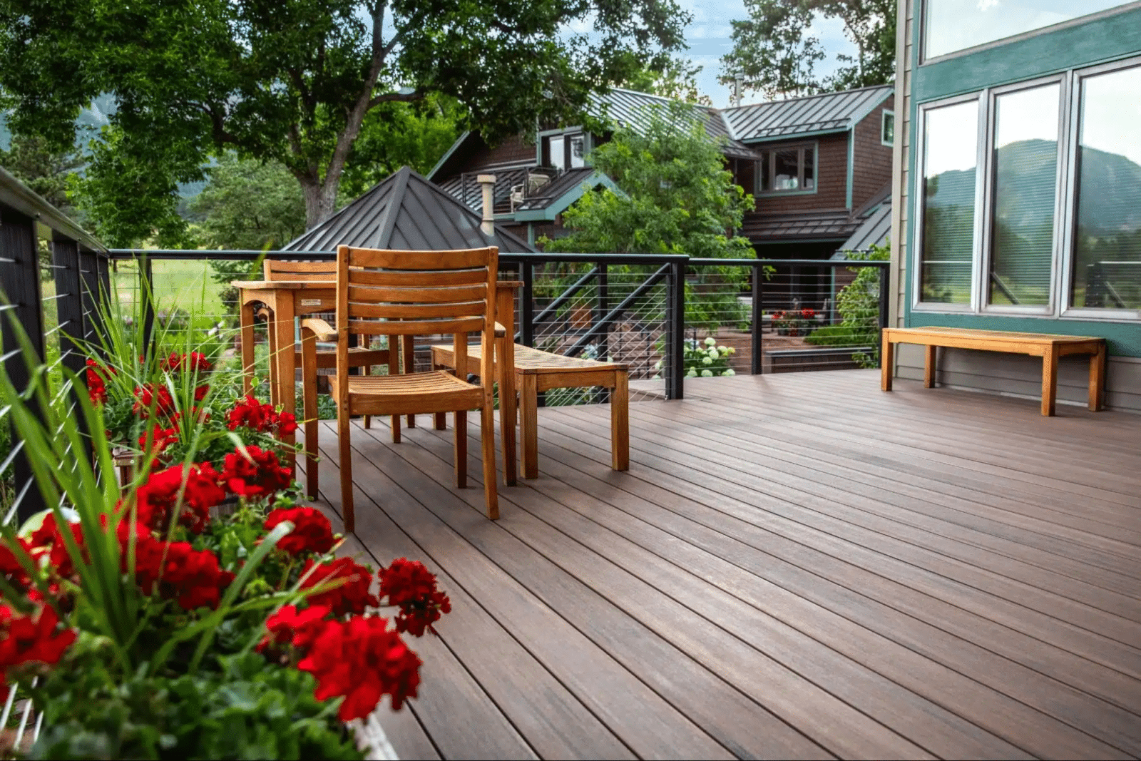 photo of a composite deck with cable deck railing and outdoor furniture - Winter deck building company in Denver Colorado