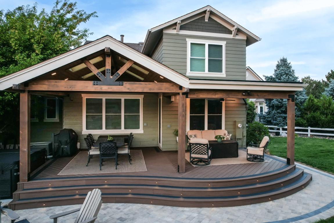 photo of a curved composite deck and patio with a louvered roof patio cover - Building a deck in winter with composite materials - Deck contractors