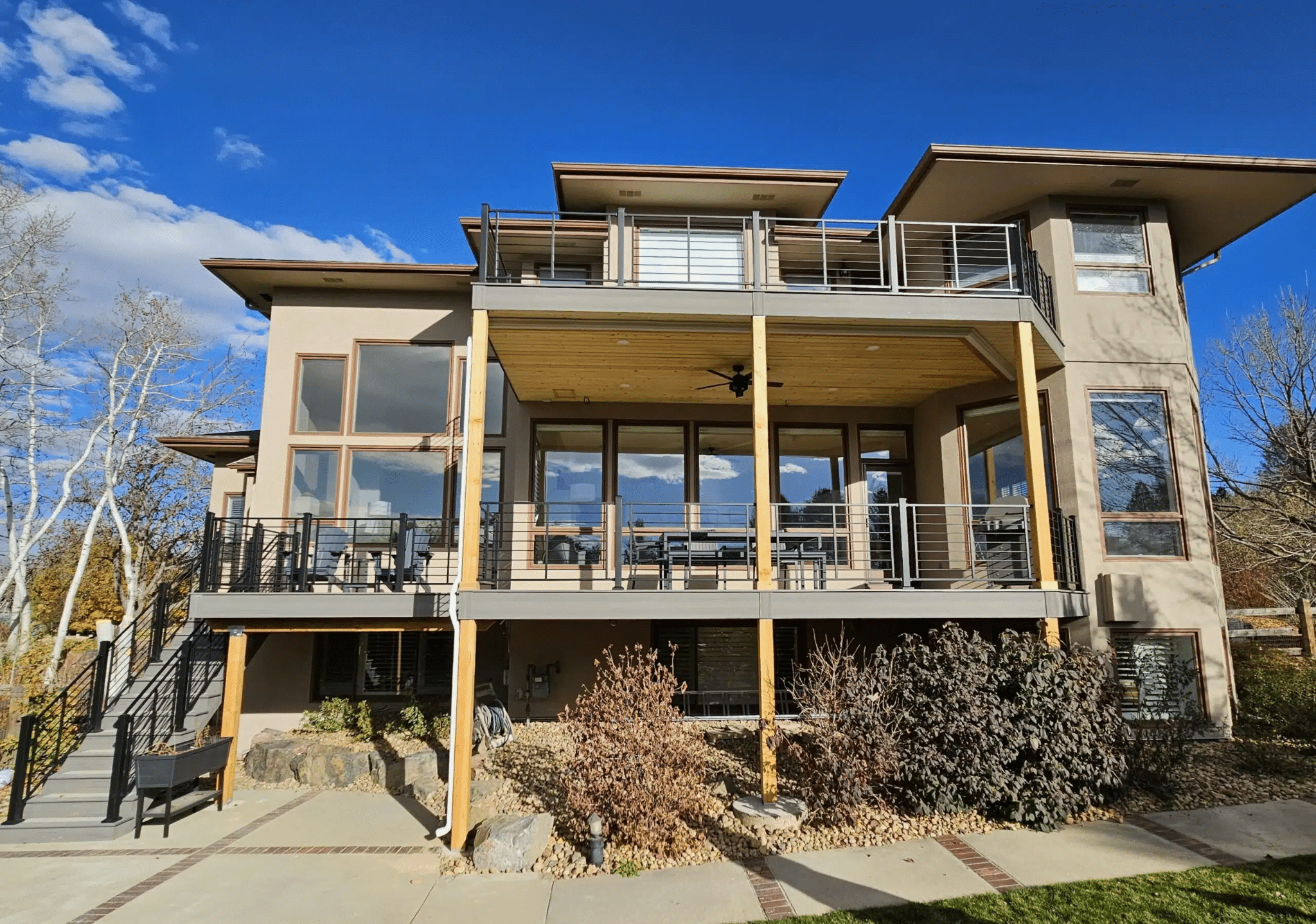 photo of a multi-level deck with patio and second story deck - Composite Decking Contractors in winter