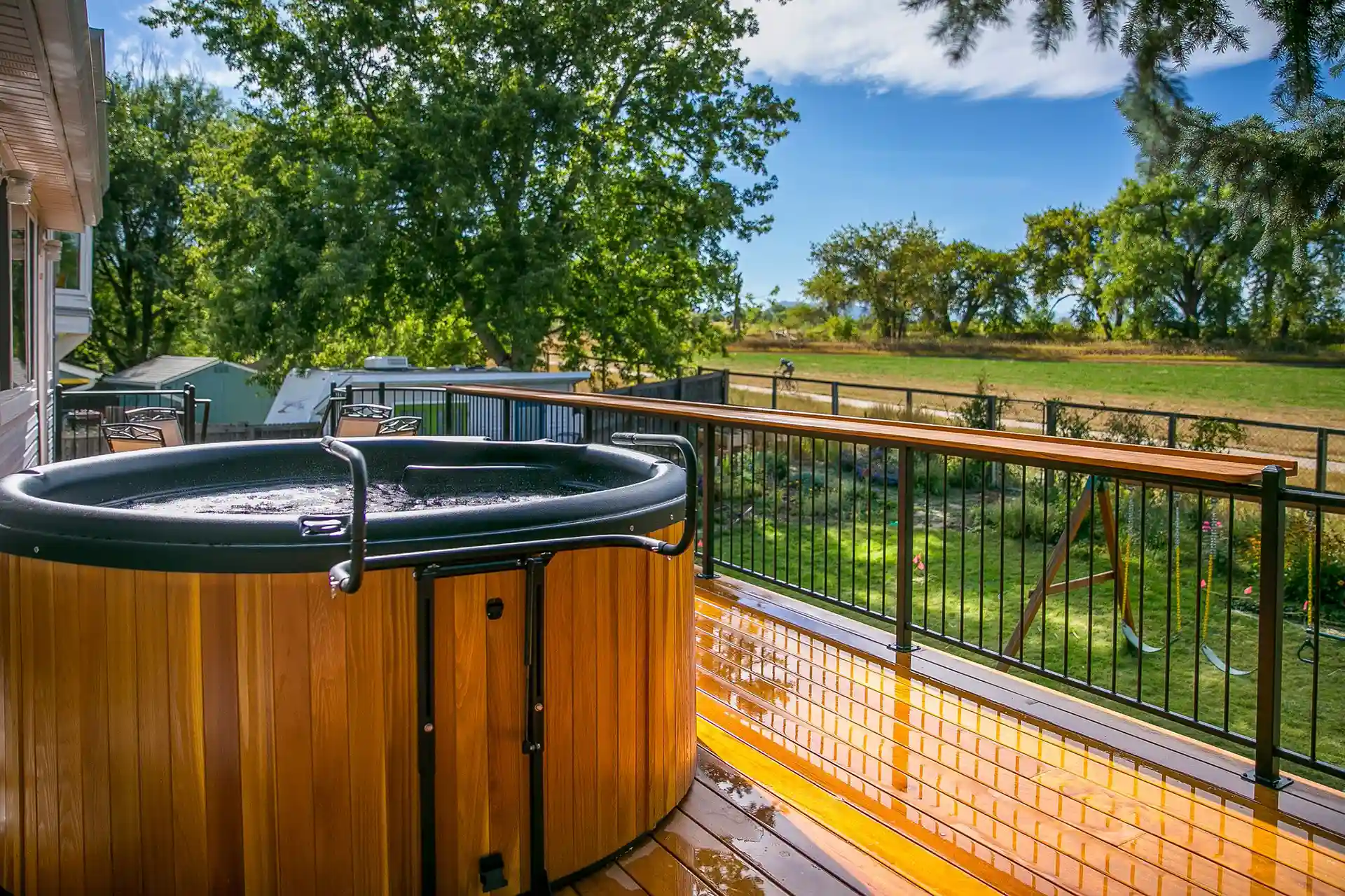 Hot tub in a multi-level deck with black railings - Custom Deck Design and Construction in Castle Rock, Co