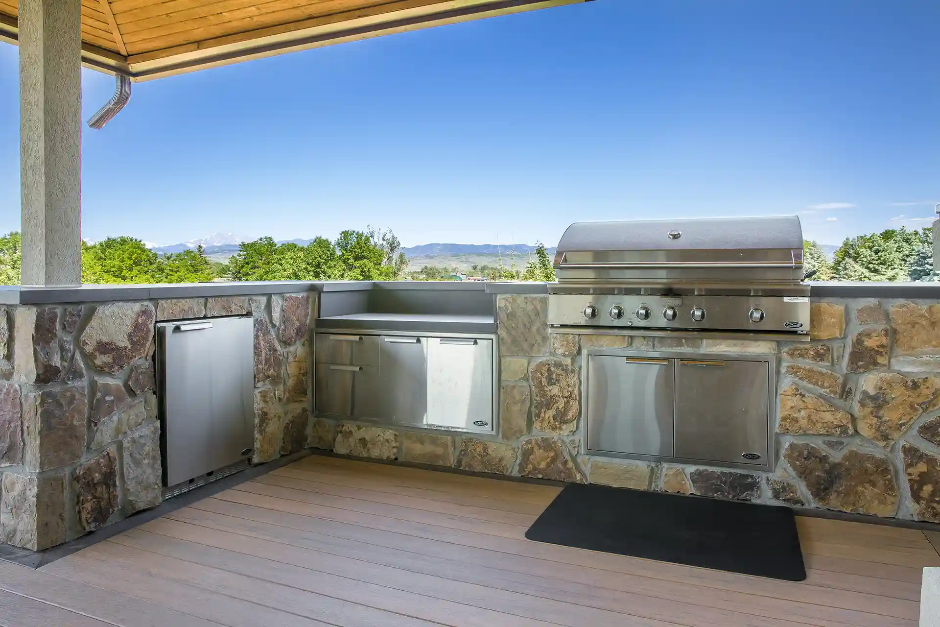 Covered deck with an outdoor kitchen and mountain views.